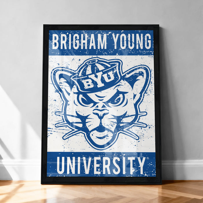 A framed poster with the text "BRIGHAM YOUNG UNIVERSITY" and an illustration of a cat wearing a hat.