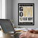 A framed poster with the text "GO ARMY BEAT NAVY" hangs on a wall above a desk with a laptop and other items.