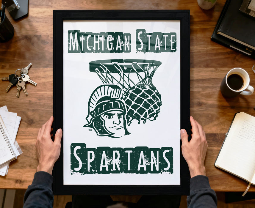 A framed poster with the text "Michigan State Spartans" and a graphic of a Greek soldier holding a basketball hoop.