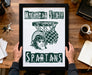 A framed poster with the text "Michigan State Spartans" and a graphic of a Greek soldier holding a basketball hoop.