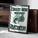 A framed poster with the Michigan State University (MSU) logo and the word "SPARTANS" printed on it, placed on a carpeted floor next to a wooden chest.