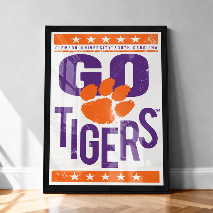A framed poster with the text "GO TIGERS" and a large paw print design, representing the Clemson Tigers football team.