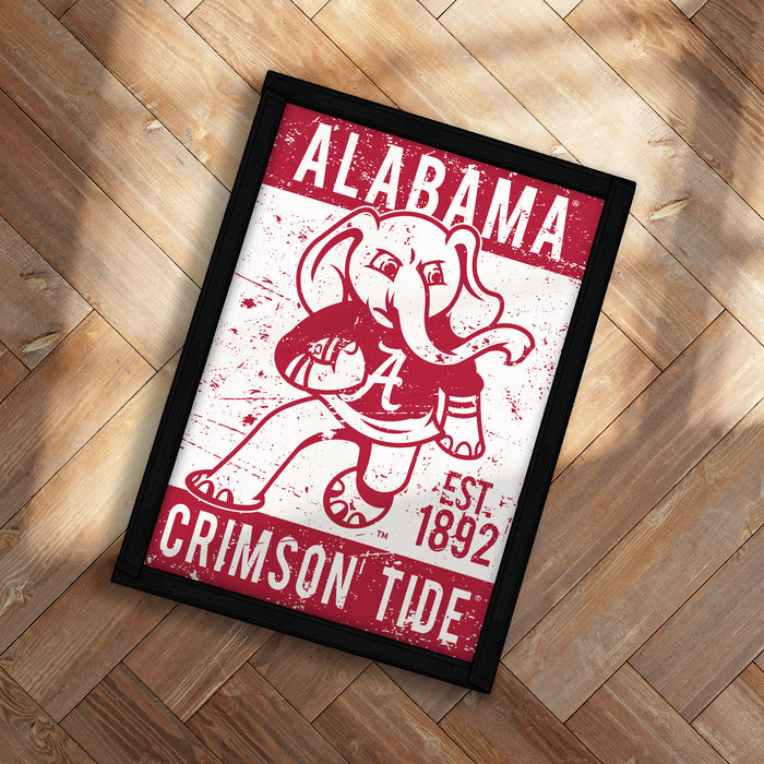 A framed poster featuring the Alabama Crimson Tide football team logo and text.