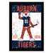 a framed poster with a tiger mascot wearing a football jersey and the text "AUBURN TIGERS" prominently displayed.