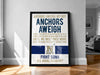 The image is a framed poster with text and a Navy logo, placed on a wooden floor in a room.