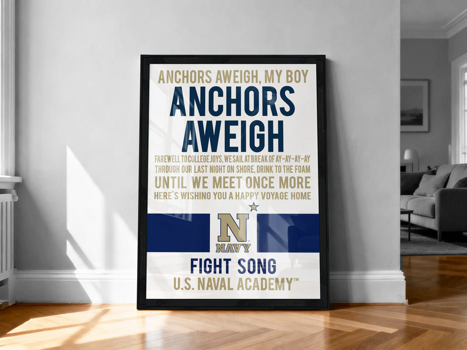 The image is a framed poster with text and a Navy logo, placed on a wooden floor in a room.