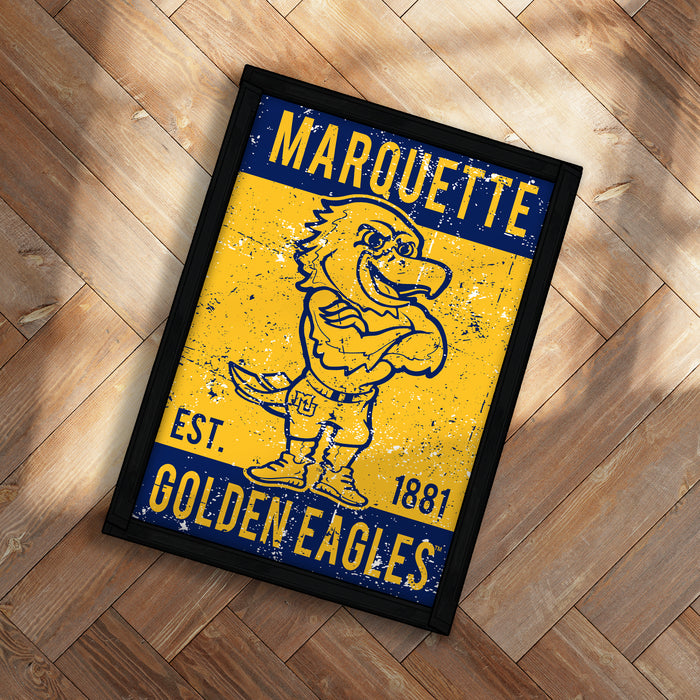 A framed poster featuring a yellow and blue design with a cartoon bird character, likely representing the Marquette University Golden Eagles.