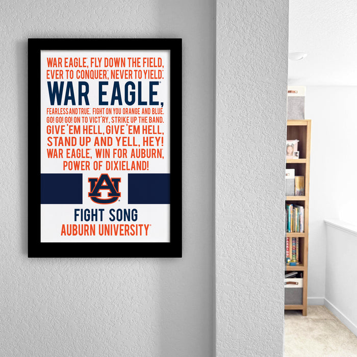 a framed poster with text and an Alabama flag design, hanging on a wall.