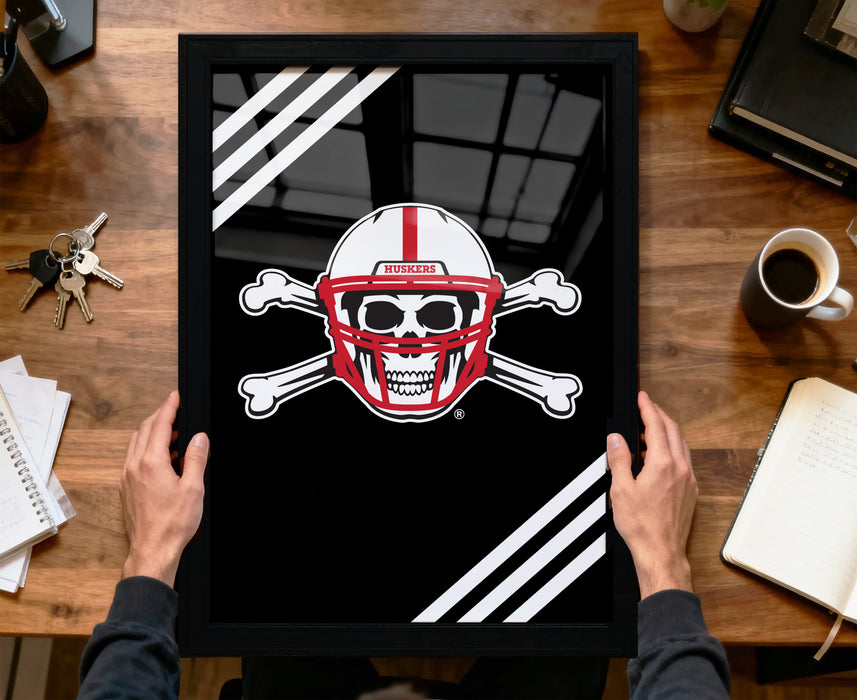 A framed image of a skull wearing a football helmet with crossed bones, accompanied by the text "HUSKIES" on the helmet.