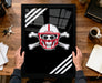 A framed image of a skull wearing a football helmet with crossed bones, accompanied by the text "HUSKIES" on the helmet.