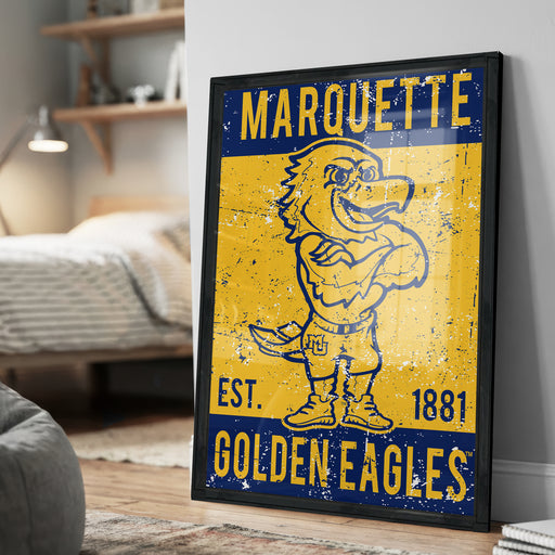 A framed poster of a cartoon eagle, with the text "MARQUETTE EST. 1881 GOLDEN EAGLES" printed on it.