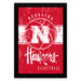 A framed poster featuring the logo and text for the Nebraska Huskers basketball team.