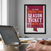 a framed poster advertising Virginia Tech's season ticket holder, with a person's hands typing on a laptop in the foreground.