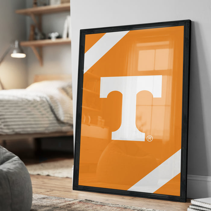 a large orange poster with a white "T" on it, displayed on a wall in a room.
