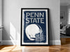 A framed poster of a football helmet with the text "PENN STATE" on it, displayed on a wall in a room.