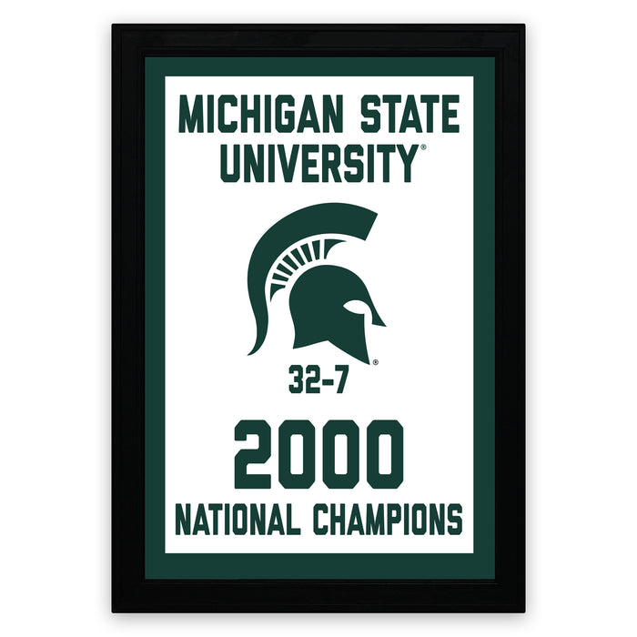 A framed poster celebrating the Michigan State University (MSU) National Champions, featuring the university's logo and the text "Michigan State University" and "2000 National Champions".