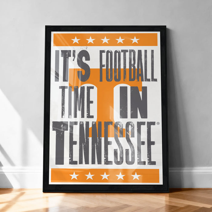 A framed poster with the text "IT'S FOOTBALL TIME IN TENNESSEE" and an orange and white design featuring a large "T" and stars.