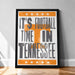 A framed poster with the text "IT'S FOOTBALL TIME IN TENNESSEE" and an orange and white design featuring a large "T" and stars.