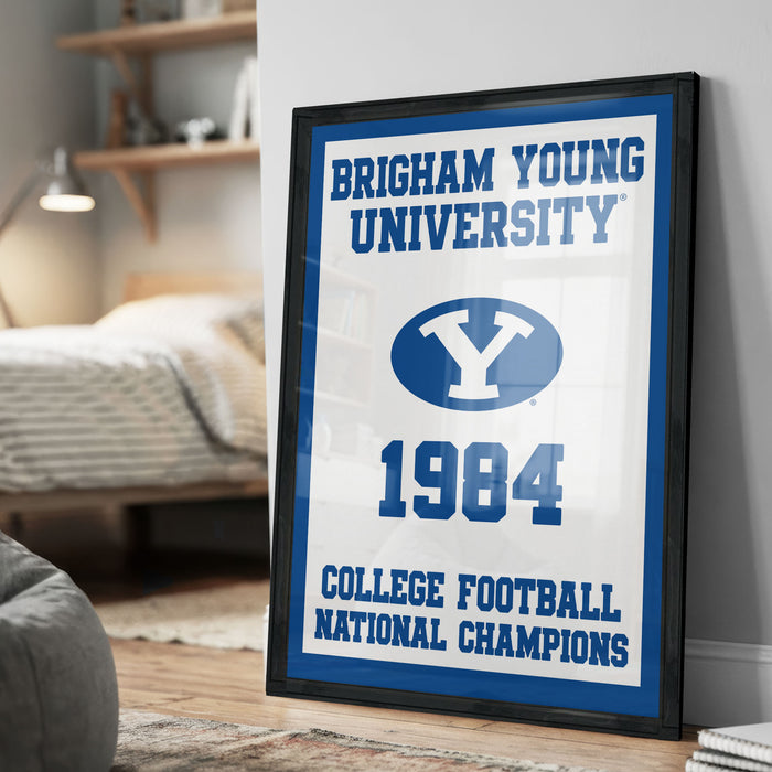 A framed poster on a wall celebrating the College Football National Champions of 1984 at Brigham Young University.