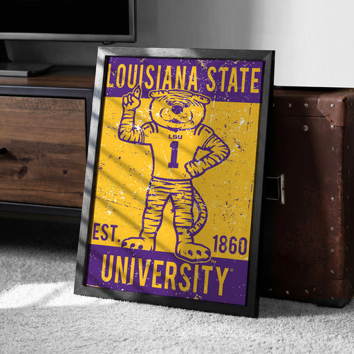 A framed poster featuring a cartoon tiger wearing a Louisiana State University jersey, with the text "LOUISIANA STATE EST. 1860 UNIVERSITY" displayed prominently.