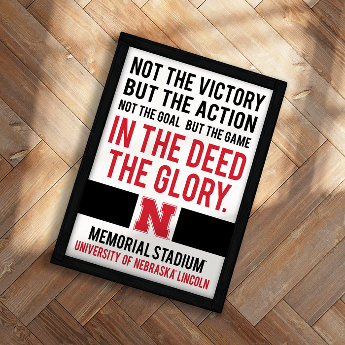The image is a framed poster with a motivational message about the importance of action and determination in achieving victory, not just the goal itself.
