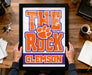 A framed poster with the text "THE ROCK CLIMB" and a large orange paw print, representing the University of South Carolina's football team.